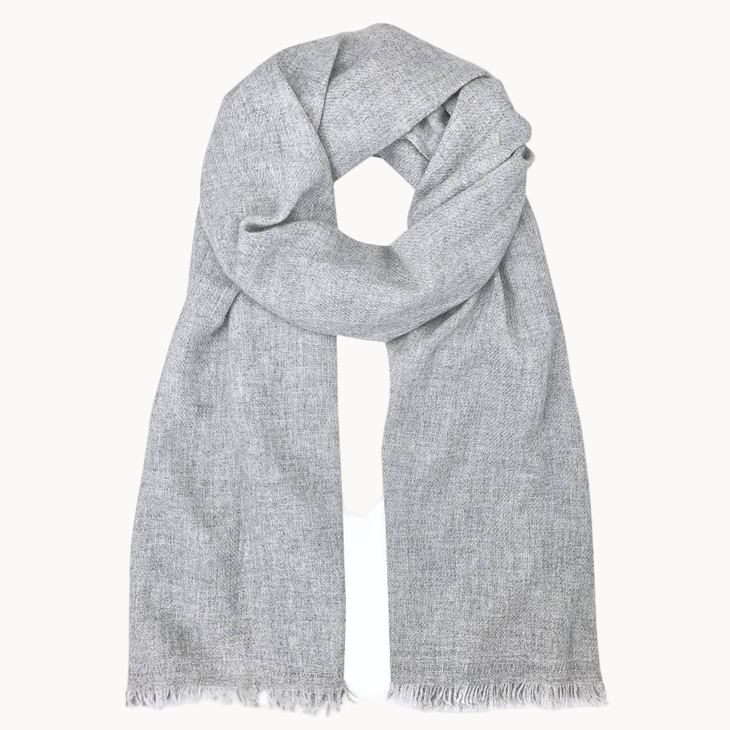 Gray cashmere scarf with frayed edges on a white background