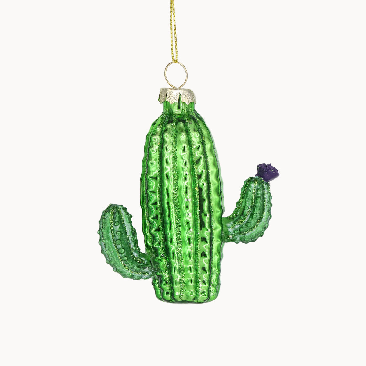 Green glass cactus ornament on a white background