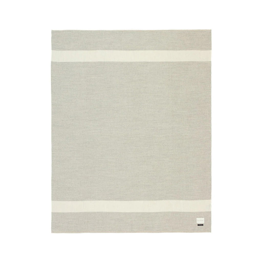 Soft beige Aplaca blanket with two ivory stripes on both ends on a white background