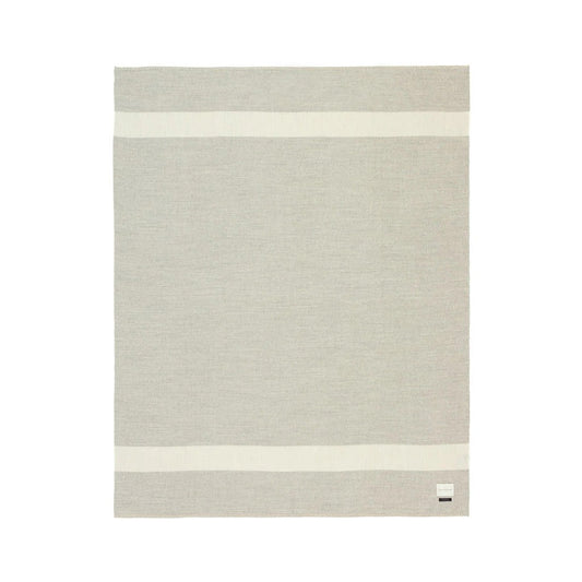 Soft beige Aplaca blanket with two ivory stripes on both ends on a white background