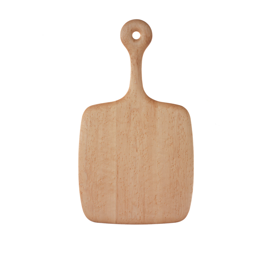 A beige birdseye maple cutting board with a rounded handle, isolated on a white background.