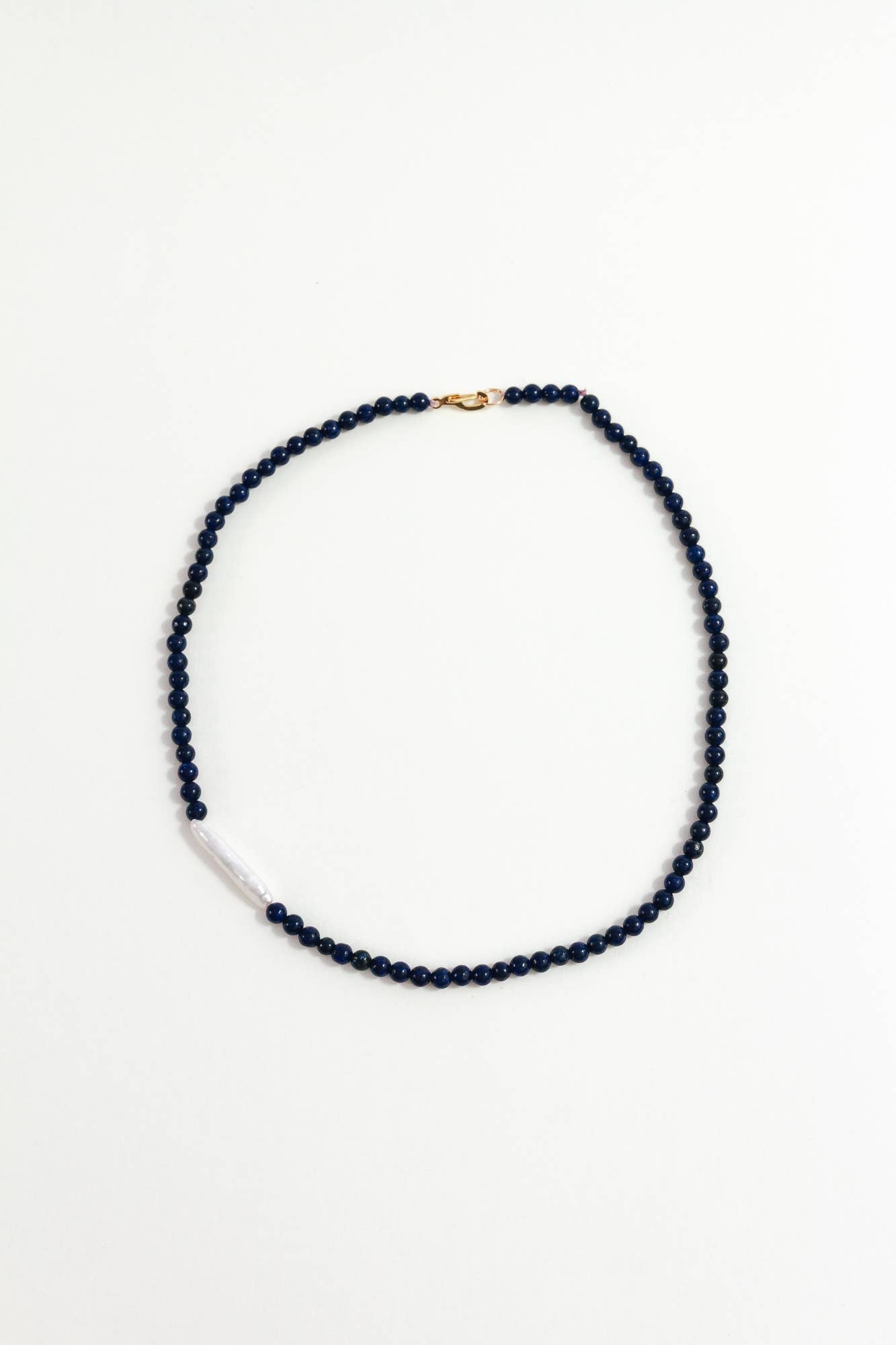 Navy blue beaded necklace on a white background