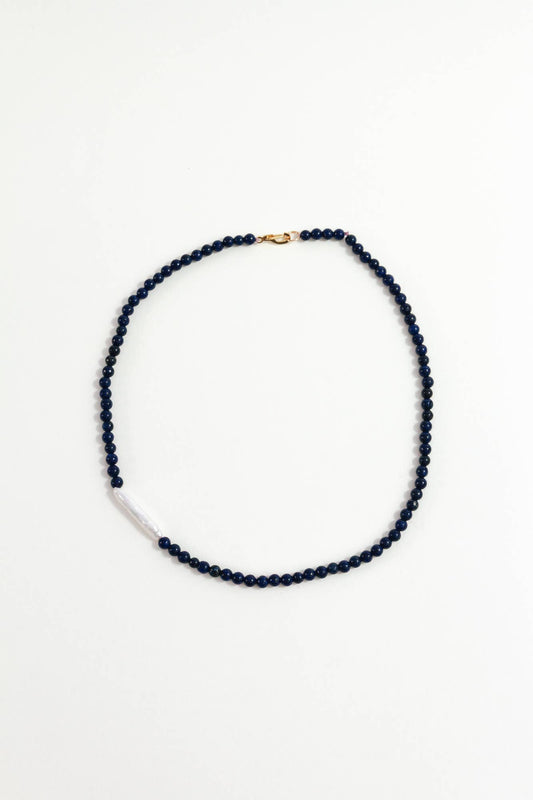 Navy blue beaded necklace on a white background