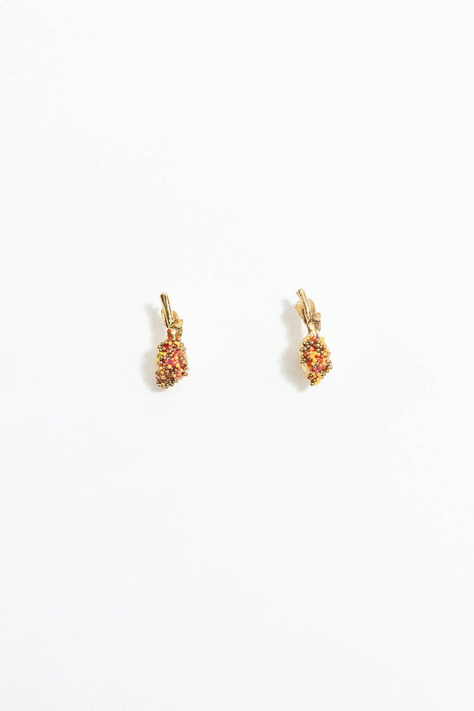 Pair of gold lemon-shaped stud earrings with red and yellow beading on a white background