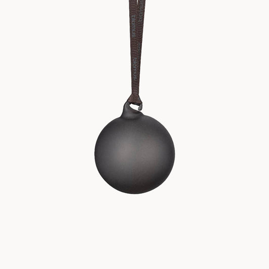 Black spherical pendant on a brown cord against a white background