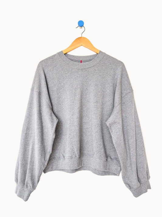 Gray sweatshirt on a hanger against a white background