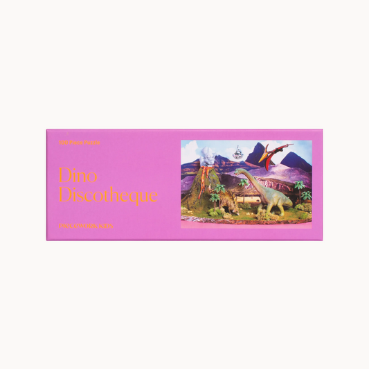 Pink packaging for 'Dino Discotheque' puzzle with dinosaur illustration on a white background