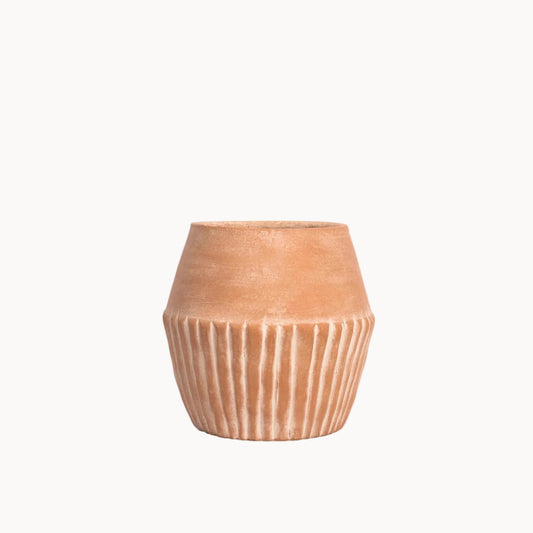 Terracotta pot with ribbed texture on a white background