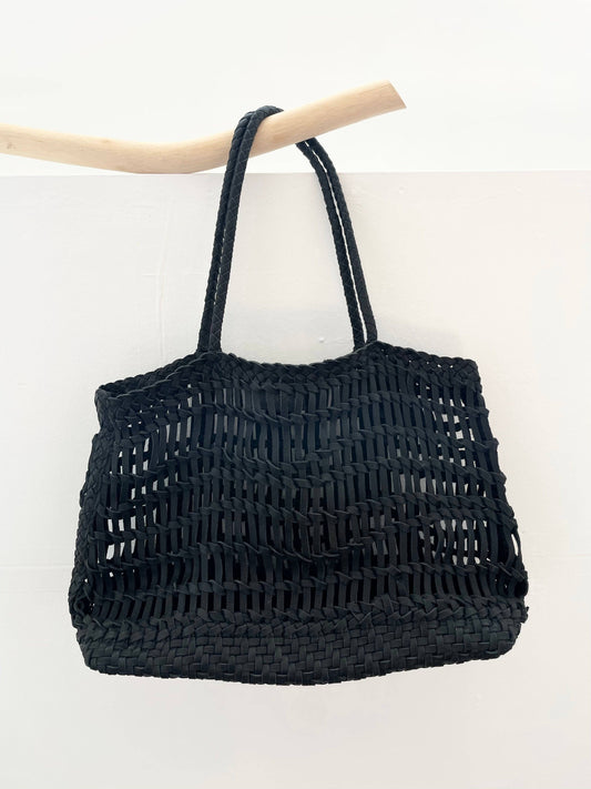 Black woven leather handbag on a white background