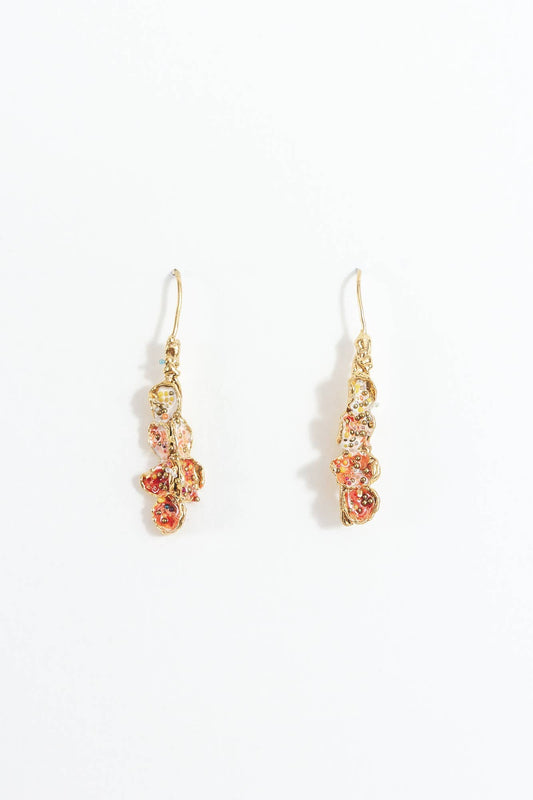 Pair of red, soft pink, and white earrings set in brass and displayed on a white background