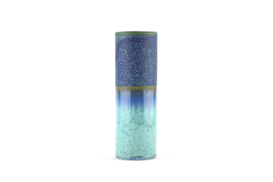 Tall cylindrical vase with gradient color from blue to green on a white background