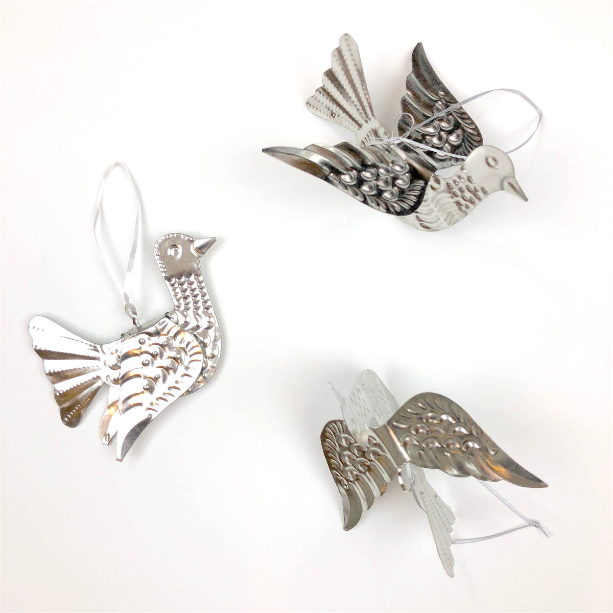 Silver bird-shaped ornament on a white background