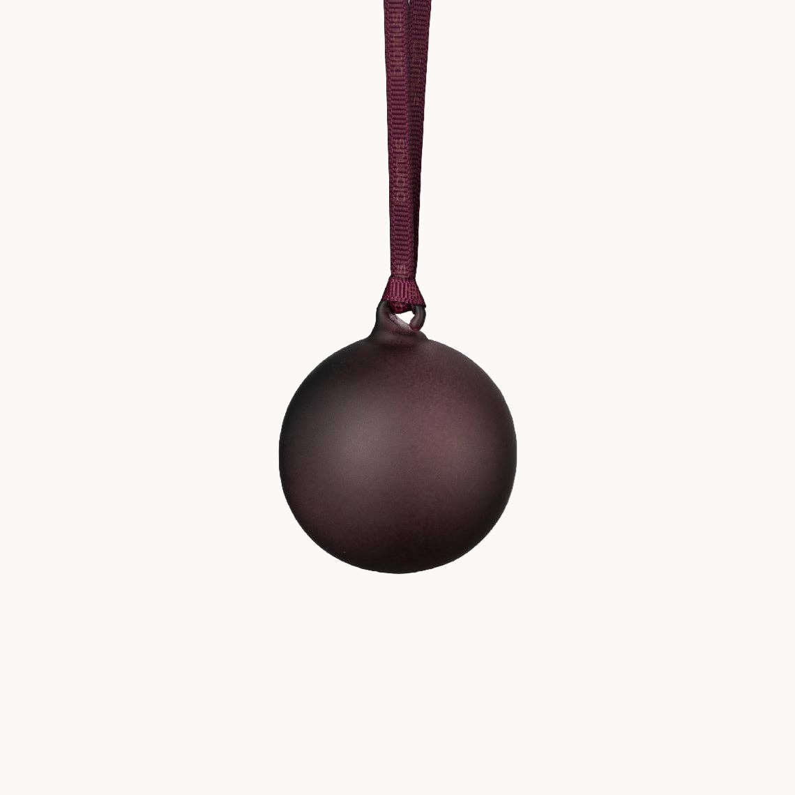 Dark plum ball ornament with a matching ribbon on a white background