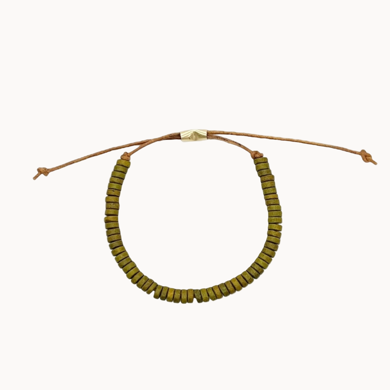 Bracelet with olive green beads on a brown leather cord on a white background