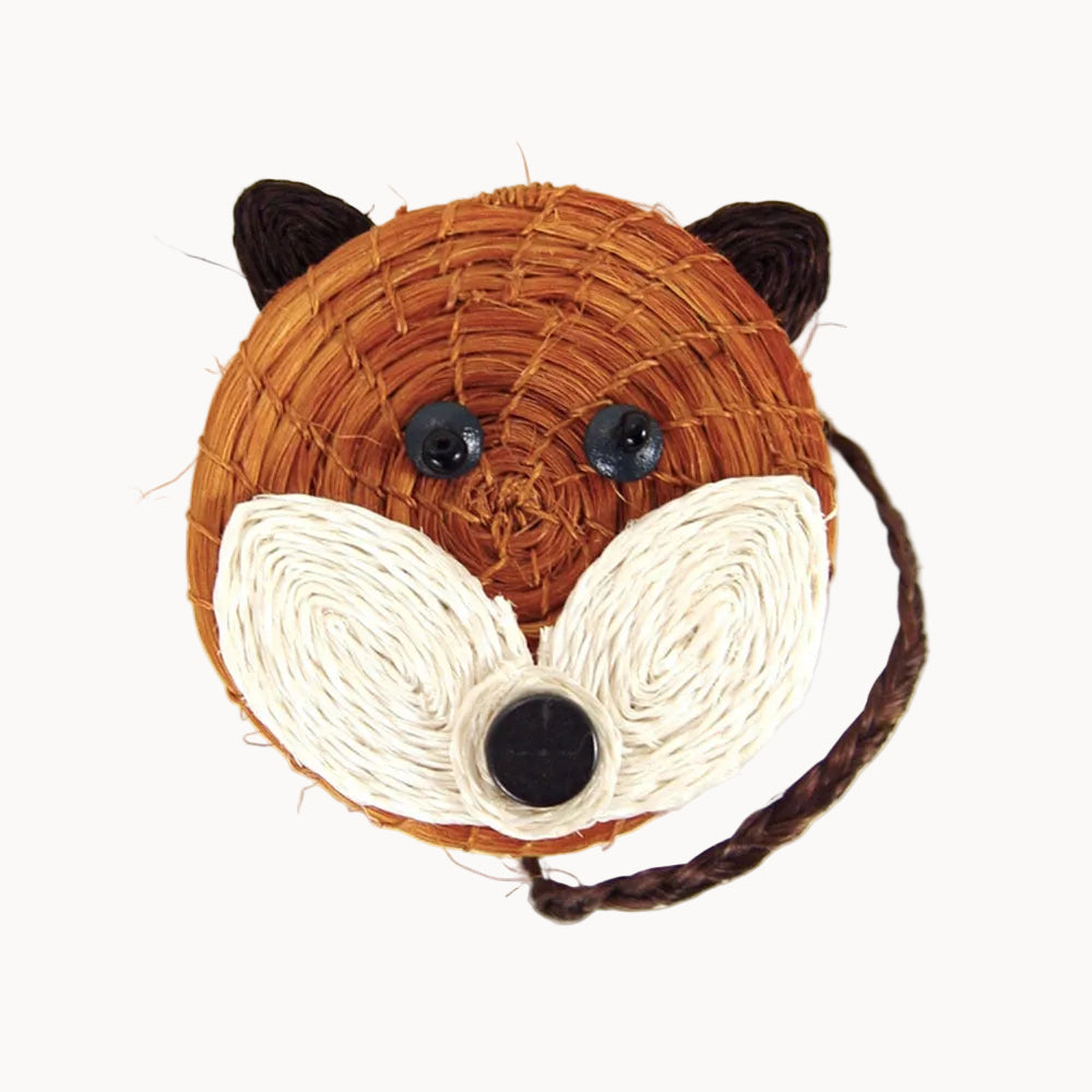 Small woven basket with a fox face on the top of the lid against a white background