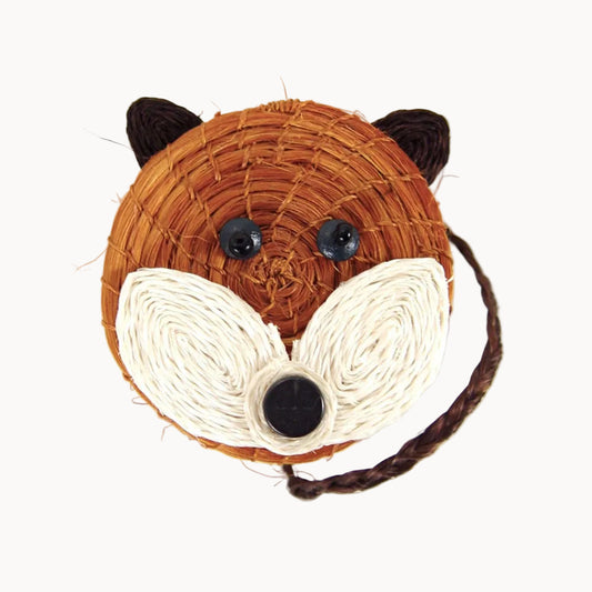 Small woven basket with a fox face on the top of the lid against a white background