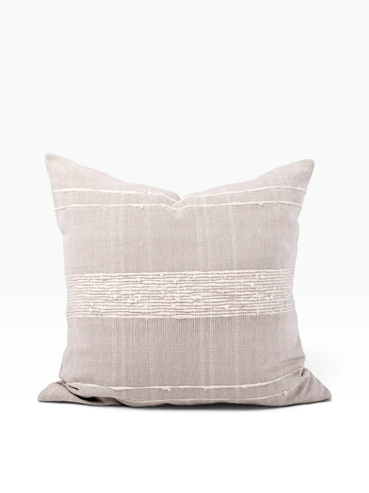 A square throw pillow in a textured light beige linen fabric with a horizontal band of white embroidered stripes across the center, set against a plain white background.