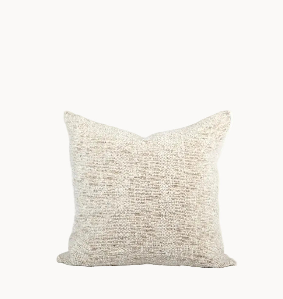 A square throw pillow in a textured cream and beige woven fabric, shown against a plain white background.