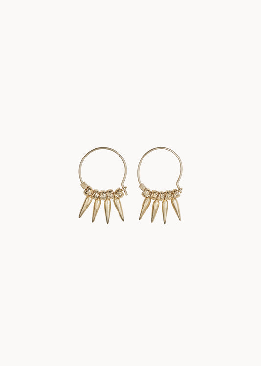 Gold hoop earrings with dangling spike details on a soft white background
