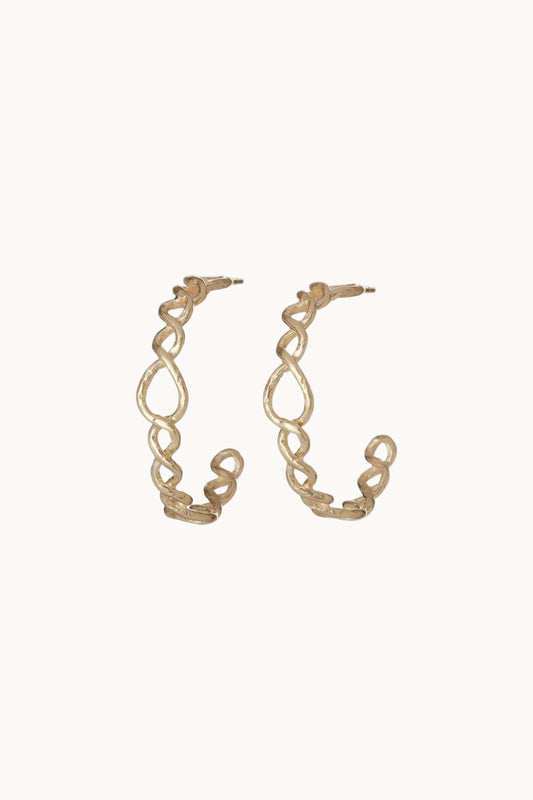 Gold braided hoop earrings on a soft white background