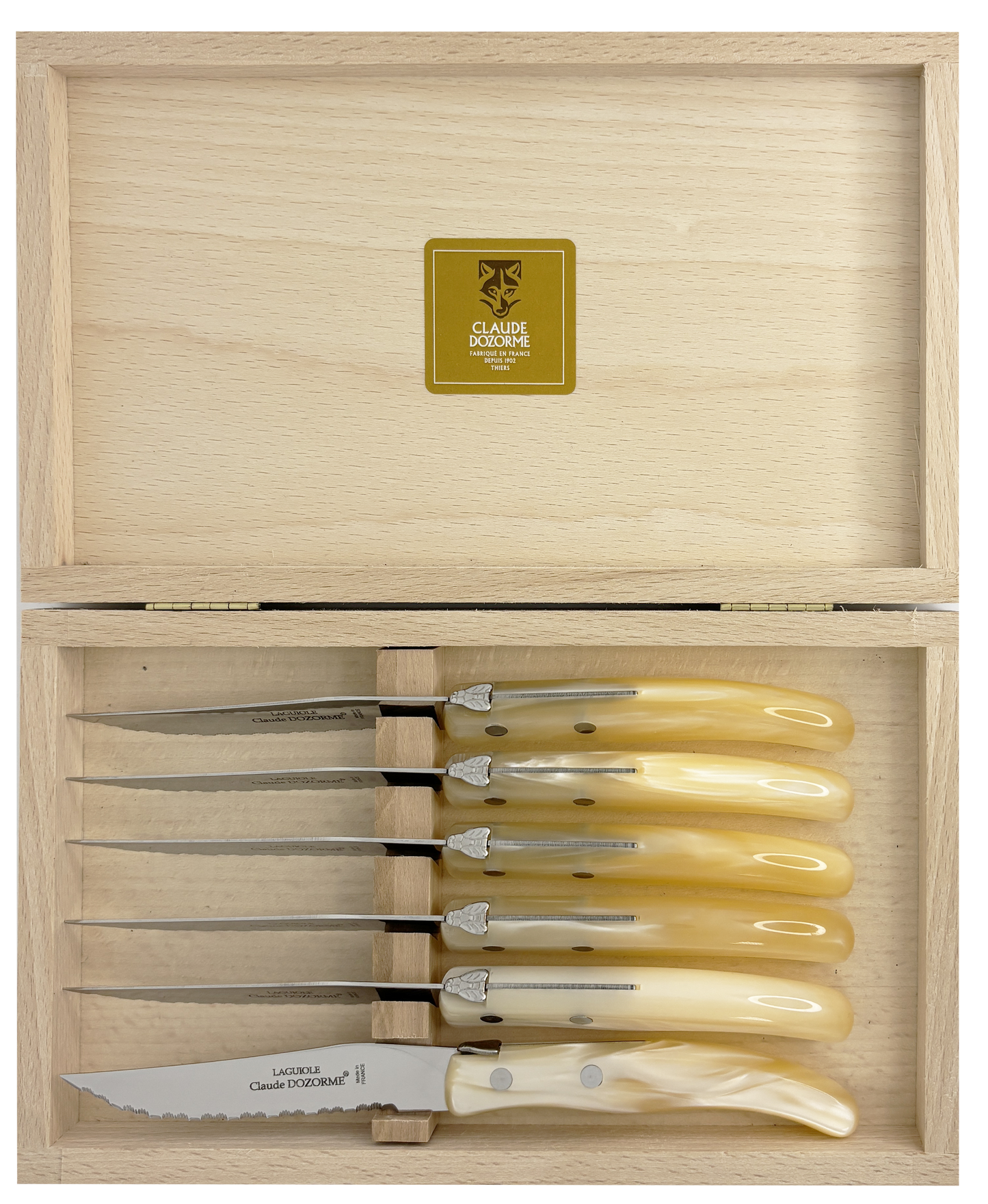 Set of six knives with ivory handles in a wooden box, featuring a brand logo.