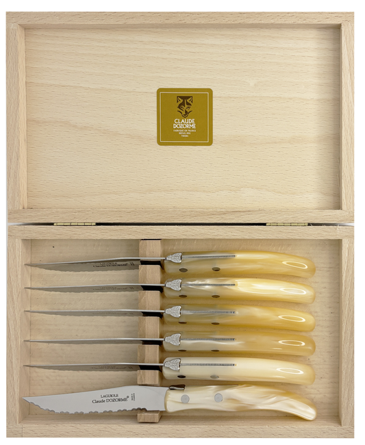 Set of six knives with ivory handles in a wooden box, featuring a brand logo.