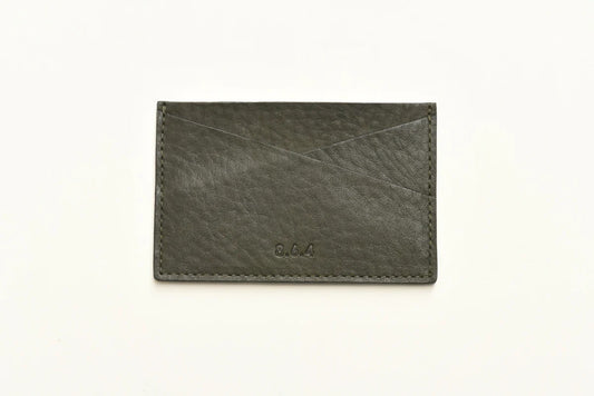 Dark green pebbled leather cardholder with on a white background