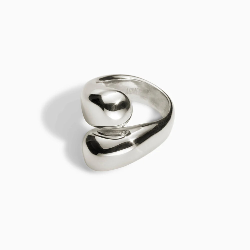 Silver sculptural ring with a wrap design on a white background