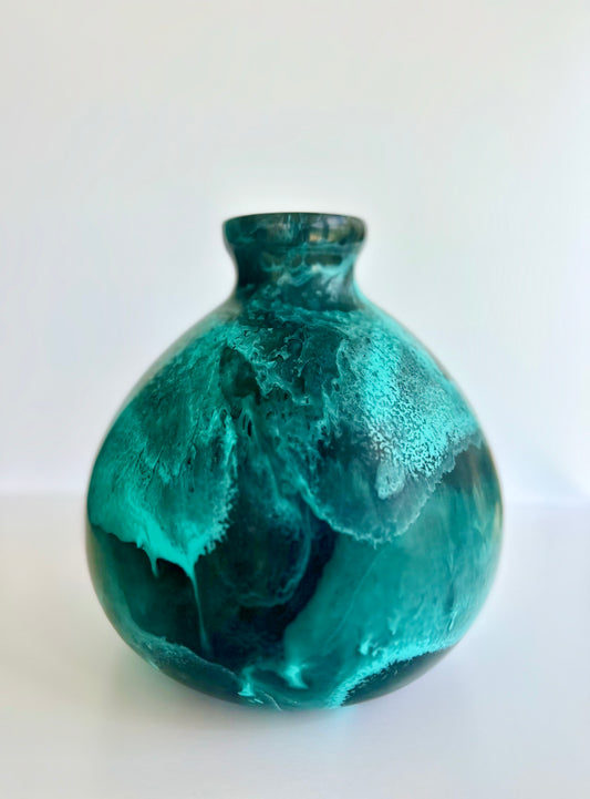 Teal marbled resin vase on a white background