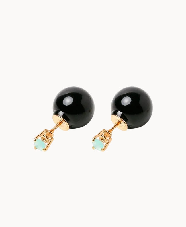 Pair of black bead earrings with gold and turquoise accents on a white background