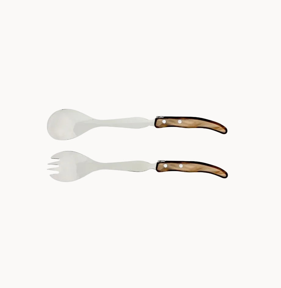 Two white salad servers with brown handles on a white background