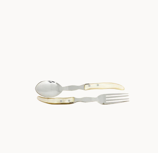 Spoon and fork serving set with ivory handles on a white background
