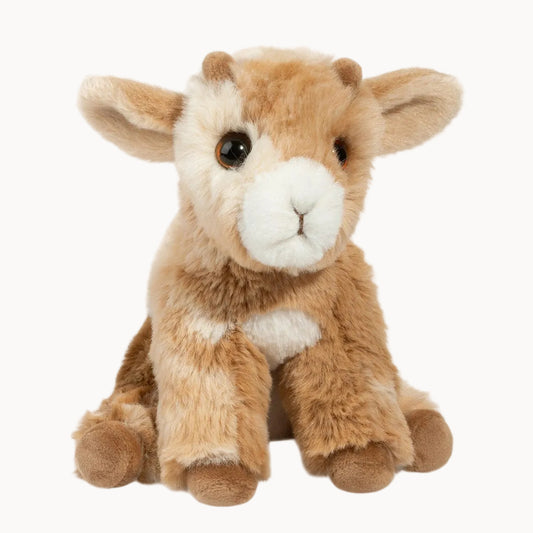 Plush toy baby goat on a white background