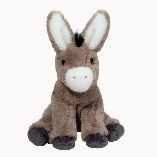Grey and black donkey plush toy on a pale gray background
