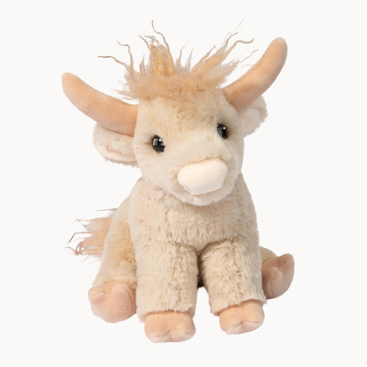Plush toy cow with horns on a white background