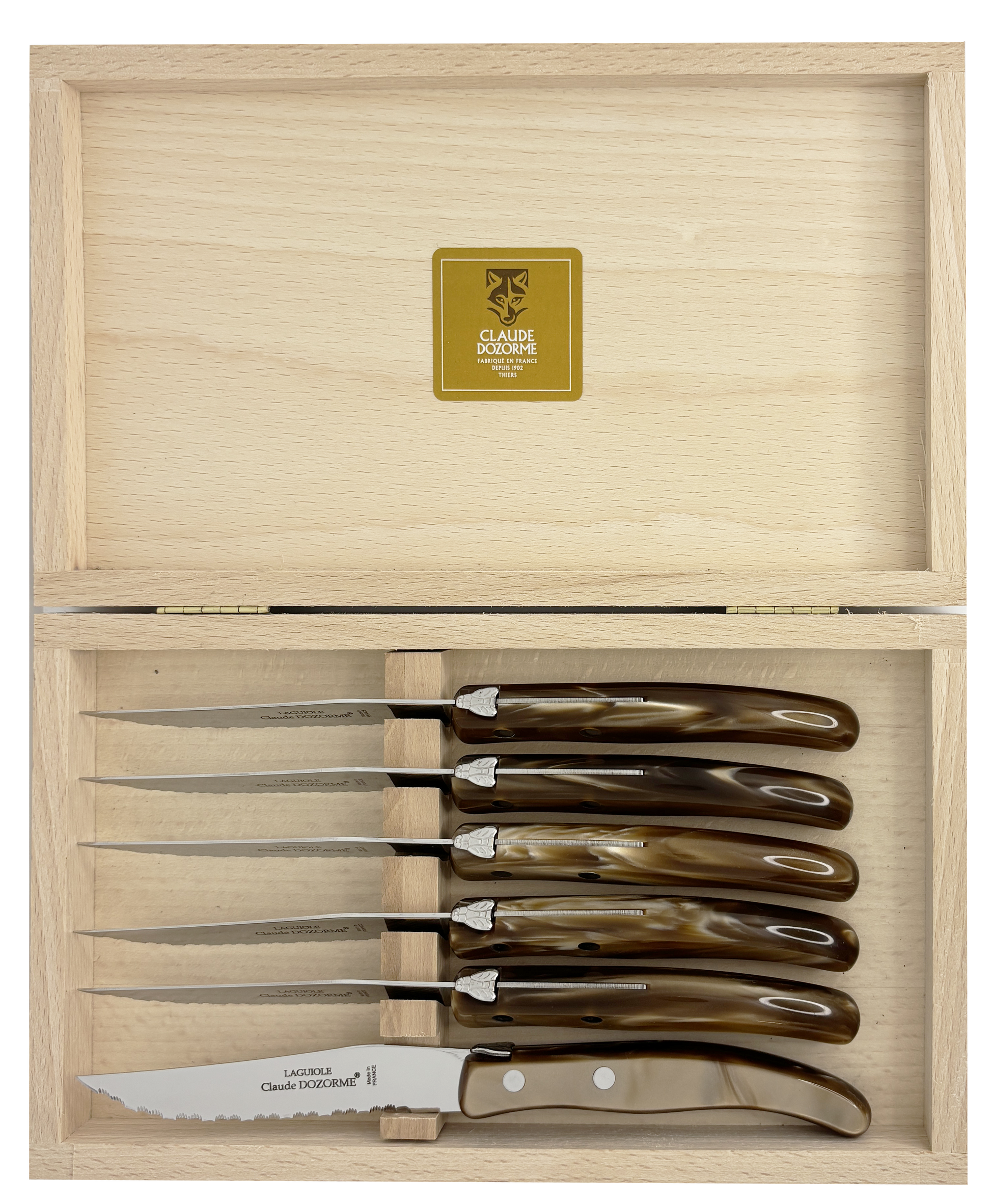 Set of six steak knives with brown resin handles in a wooden box.