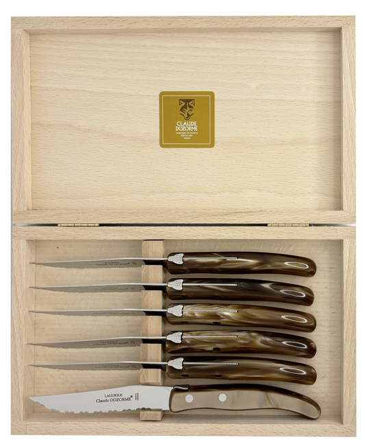 Set of six steak knives with brown resin handles in a wooden box.