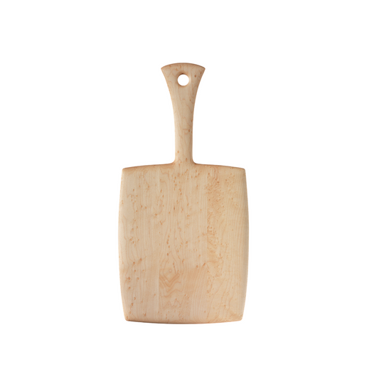 A beige birdseye maple cutting board with a straight handle, isolated on a white background.