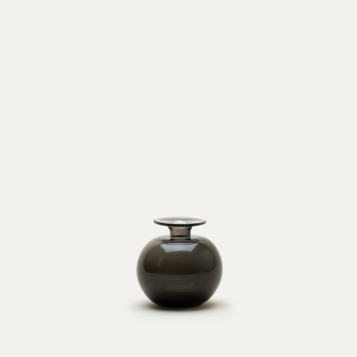 Round, black glass bud vase on a white background