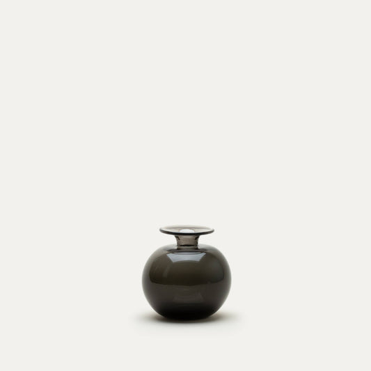 Round, black glass bud vase on a white background