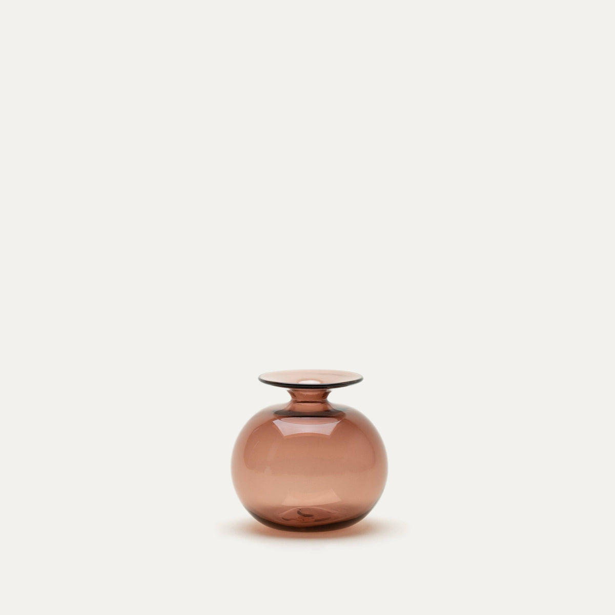 Smoky pink glass vase on a light beige background