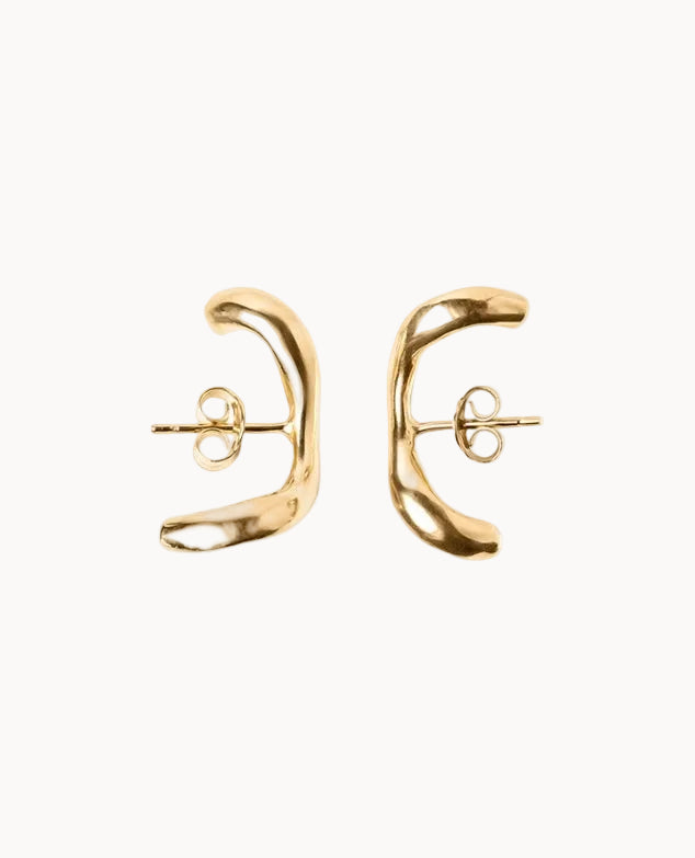 Gold earrings on a white background