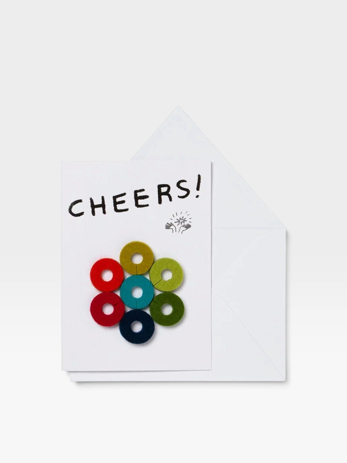 Greeting card with colorful circular felt wind glass markers affixed to the front in a round design and 'Cheers!' text above it, photographed on a white background