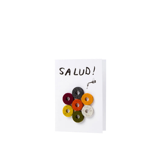Colorful wine charms on a card with 'SALUD!' text on a white background