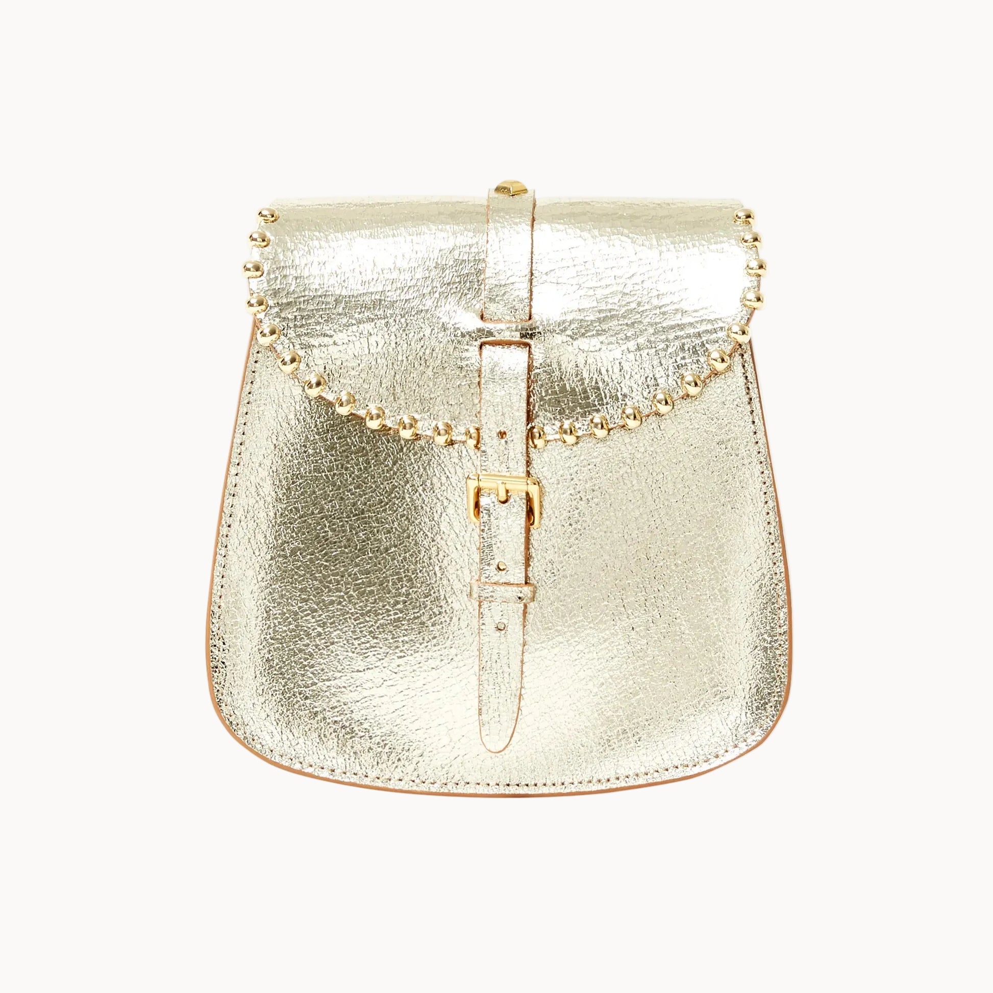 A metallic gold saddle bag with a textured leather finish, featuring a central buckle strap and beaded detailing across the top, set against a plain white background.