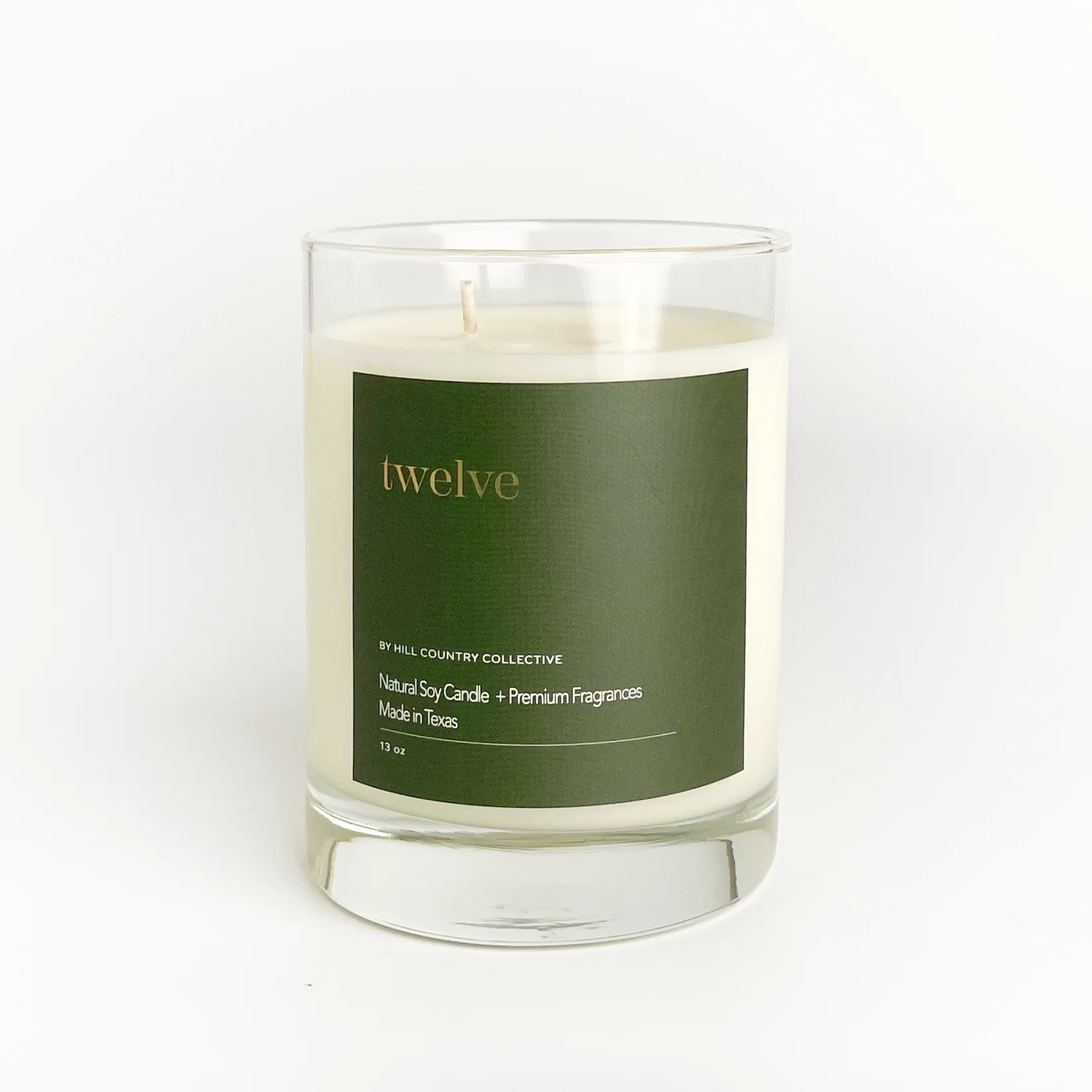 Candle with a green label on a white background