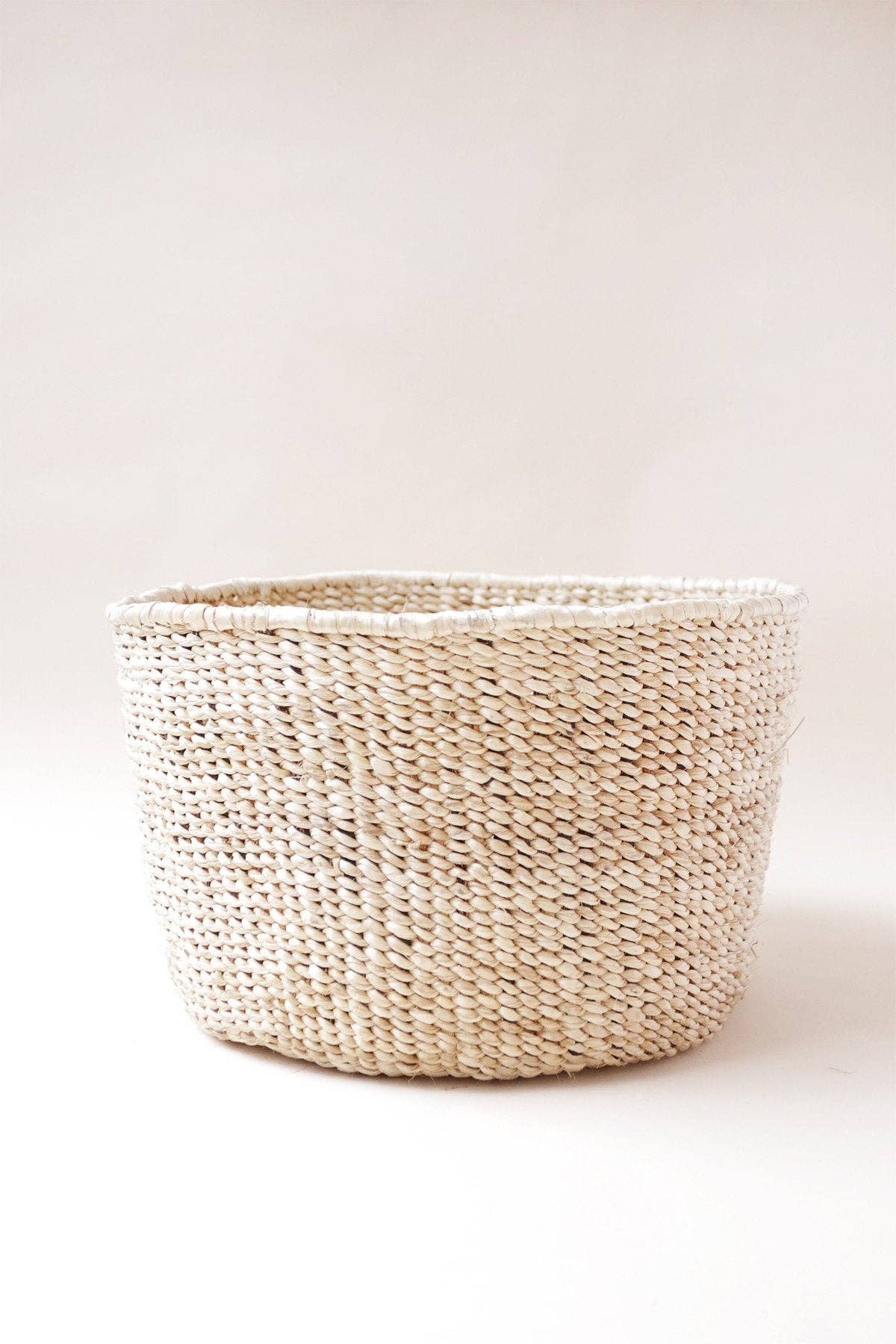 Woven floor basket on a white background