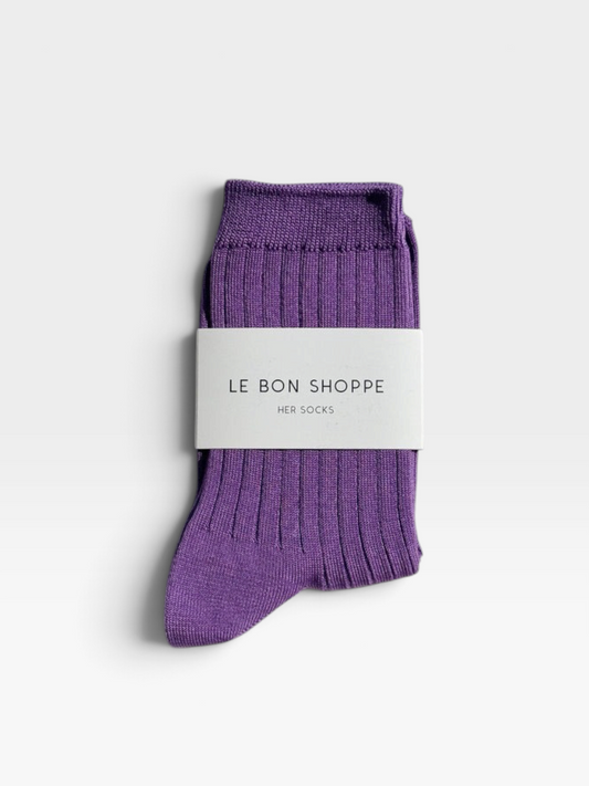 Ribbed purple cotton women's socks wrapped in white label with Le Bon Shoppe brand name printed on it set against a white background