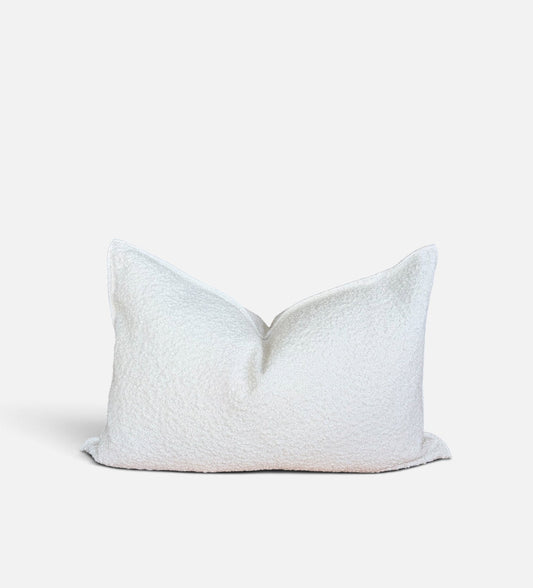 A rectangular white textured throw pillow with a soft, bouclé-like fabric, photographed against a clean white background.