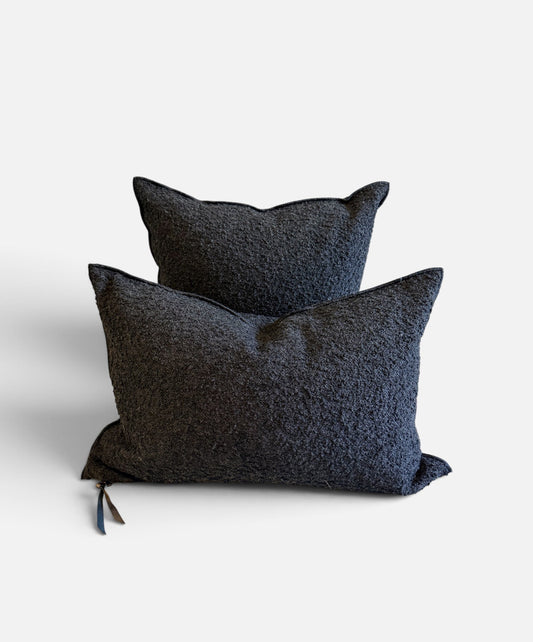 Two dark charcoal textured throw pillows stacked on a light gray background.